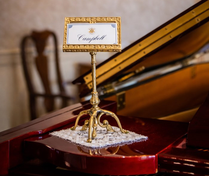 Campbell display on grand piano inside Warminster, PA funeral home and cremations with elegant memorial room décor