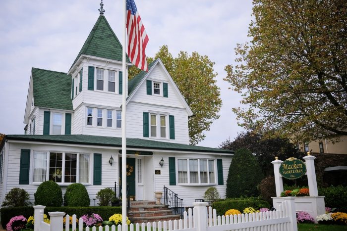 Macken Mortuary exterior representing Oceanside, NY funeral home and cremations with American flag and gardens